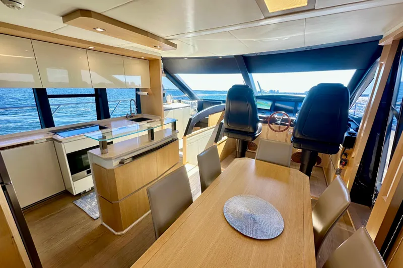  Yacht Photos Pics Luxurious interior of 2016 Absolute 72 FLY yacht with modern kitchen and dining area.