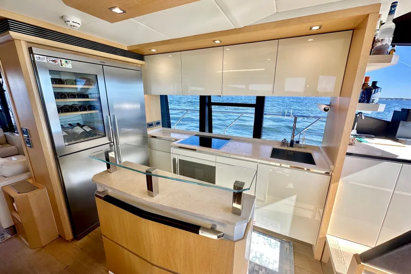  Yacht Photos Pics Luxurious kitchen interior of 2016 Absolute 72 FLY yacht with ocean view.