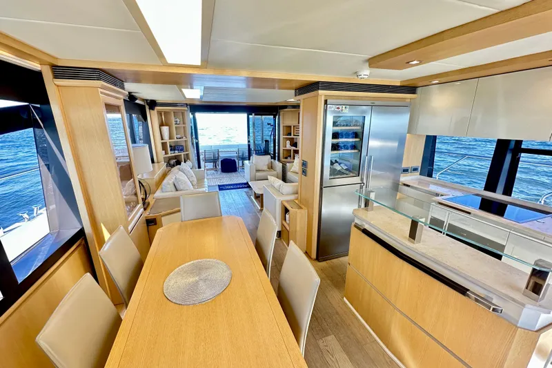  Yacht Photos Pics Luxurious interior of 2016 Absolute 72 FLY yacht with modern kitchen and dining area.