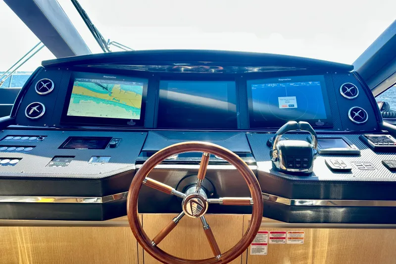  Yacht Photos Pics Cockpit of 2016 Absolute 72 FLY yacht with navigation screens and steering wheel.