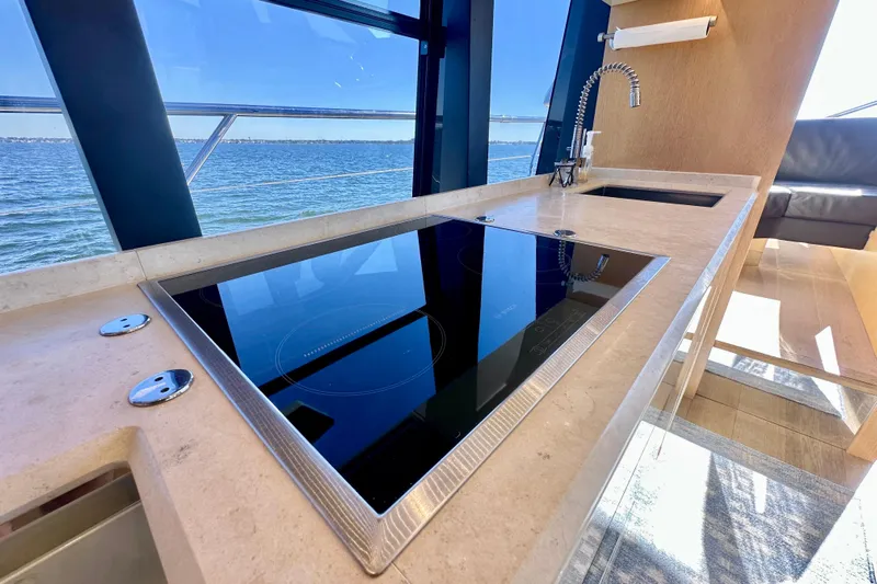  Yacht Photos Pics Luxurious kitchen on 2016 Absolute 72 FLY yacht with sleek cooktop and ocean view.