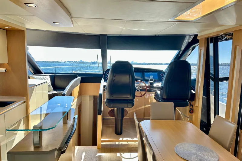  Yacht Photos Pics Luxurious interior of 2016 Absolute 72 FLY yacht with modern helm and dining area.