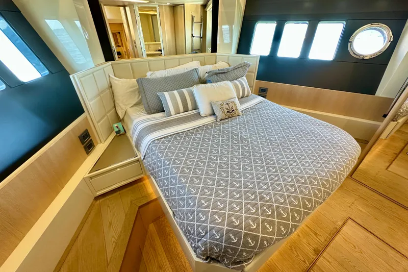  Yacht Photos Pics Luxurious bedroom interior on 2016 Absolute 72 FLY yacht with elegant bedding and wood accents.