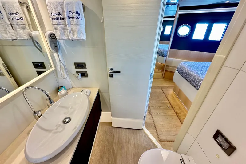  Yacht Photos Pics Luxurious bathroom and bedroom on a 2016 Absolute 72 FLY yacht, featuring modern amenities.