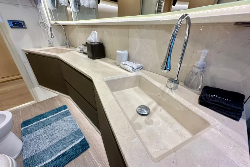  Yacht Photos Pics Luxurious bathroom interior of 2016 Absolute 72 FLY yacht with dual sinks and modern fixtures.