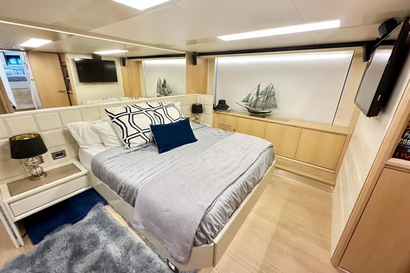  Yacht Photos Pics Luxurious bedroom interior on 2016 Absolute 72 FLY yacht, featuring modern decor and elegant furnishings.