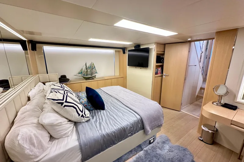  Yacht Photos Pics Luxurious bedroom interior of 2016 Absolute 72 FLY yacht with modern decor and cozy bedding.