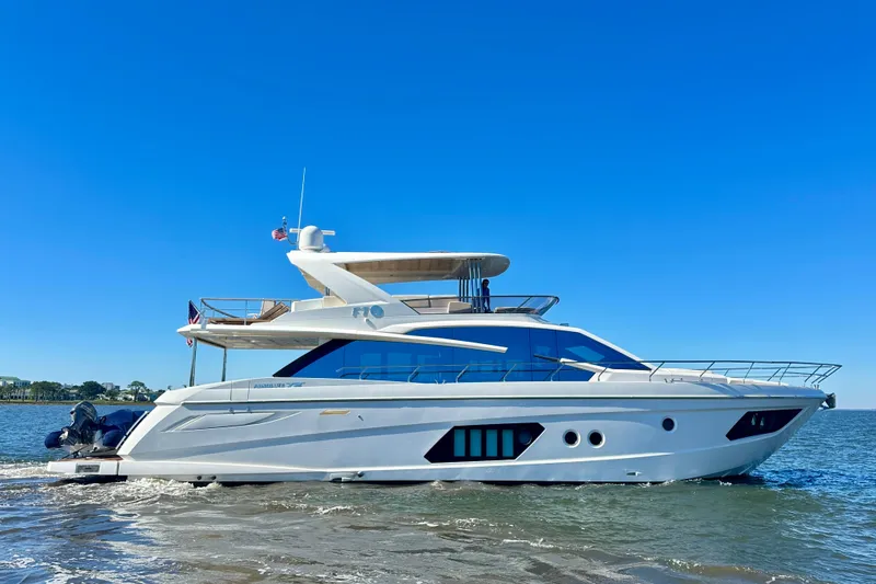  Yacht Photos Pics Luxury 2016 Absolute 72 FLY yacht cruising on open water under clear blue sky.