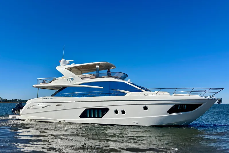  Yacht Photos Pics Luxury yacht Absolute 72 FLY 2016 cruising on open water under clear blue sky.