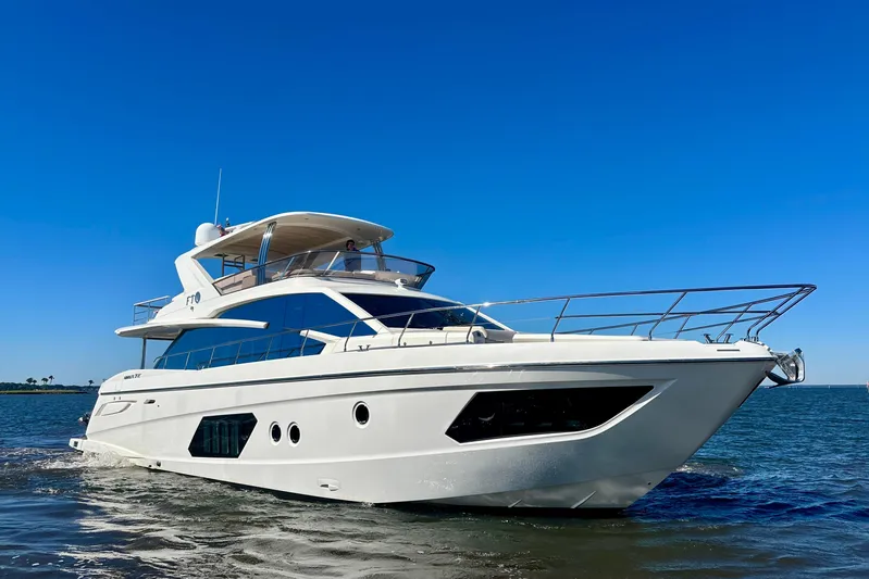  Yacht Photos Pics Luxury yacht Absolute 72 FLY 2016 cruising on open water under clear blue sky.