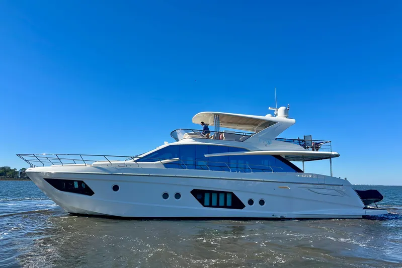  Yacht Photos Pics Luxurious 2016 Absolute 72 FLY yacht cruising on open water under clear blue sky.