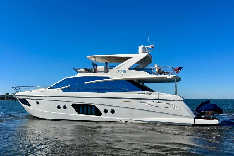  Yacht Photos Pics Luxury 2016 Absolute 72 FLY yacht cruising on open water under clear blue sky.