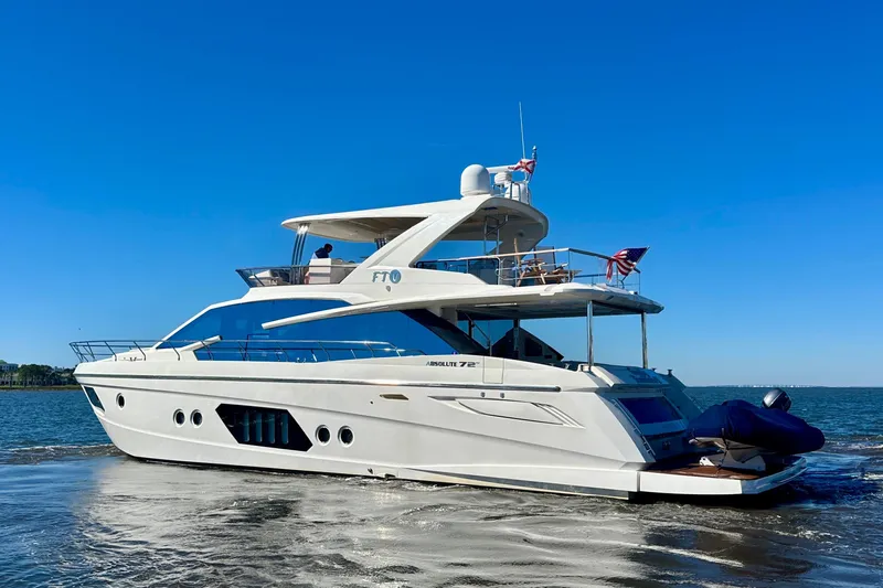  Yacht Photos Pics Luxurious 2016 Absolute 72 FLY yacht cruising on open water under clear blue skies.