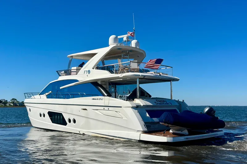  Yacht Photos Pics Luxury Absolute 72 FLY yacht from 2016 cruising on open water under clear blue skies.