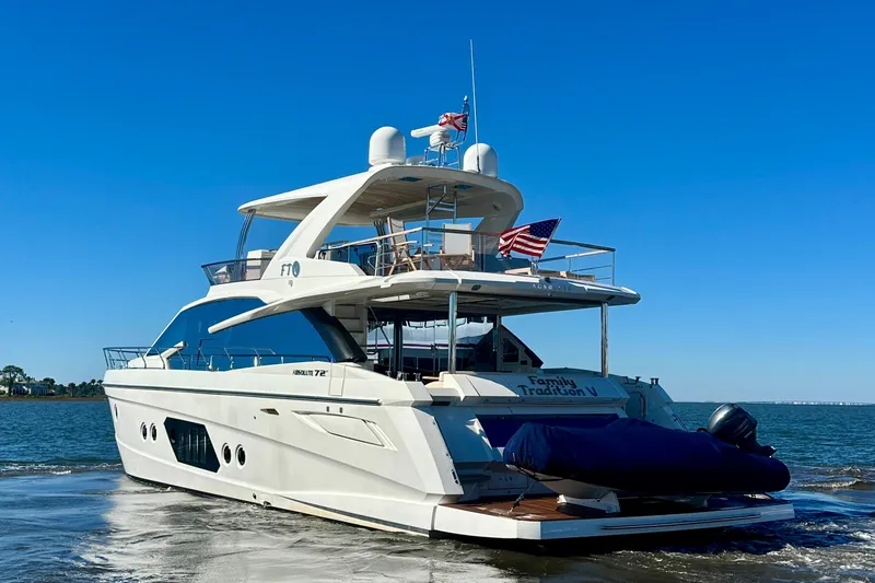  Yacht Photos Pics Luxury 2016 Absolute 72 FLY yacht cruising on open water under clear blue sky.