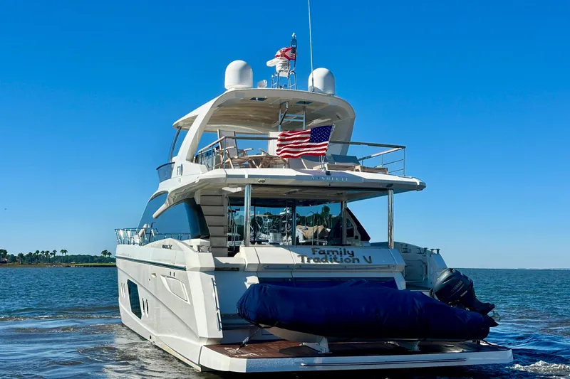  Yacht Photos Pics Luxury yacht Absolute 72 FLY 2016 on water, American flag displayed, clear blue sky.