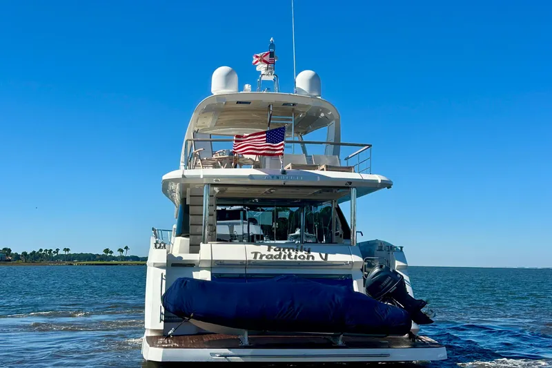  Yacht Photos Pics Luxury yacht Absolute 72 FLY 2016 cruising on open water, American flag displayed.