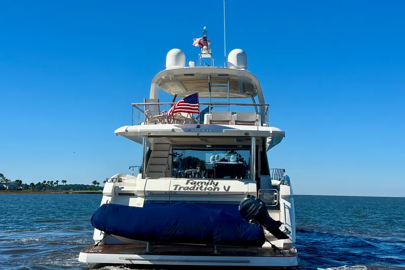  Yacht Photos Pics Luxury yacht Absolute 72 FLY 2016 cruising on open water under clear blue sky.