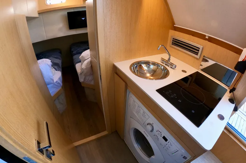  Yacht Photos Pics Compact kitchen and sleeping area in 2016 Absolute 72 FLY yacht interior.