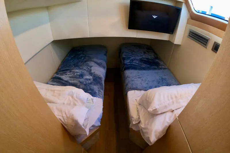  Yacht Photos Pics Twin beds in a cozy cabin of a 2016 Absolute 72 FLY yacht.