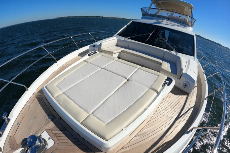  Yacht Photos Pics Luxury Absolute 72 FLY yacht deck with sunbed, 2016 model, cruising on open water.
