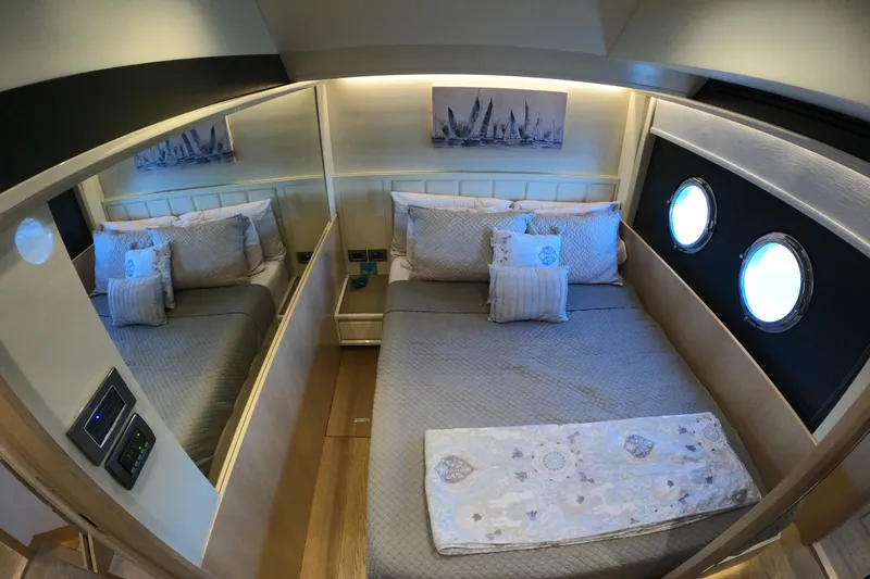  Yacht Photos Pics Luxurious bedroom interior on 2016 Absolute 72 FLY yacht with elegant bedding and porthole windows.