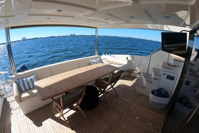  Yacht Photos Pics Luxurious Absolute 72 FLY yacht deck with seating, table, and ocean view, 2016 model.