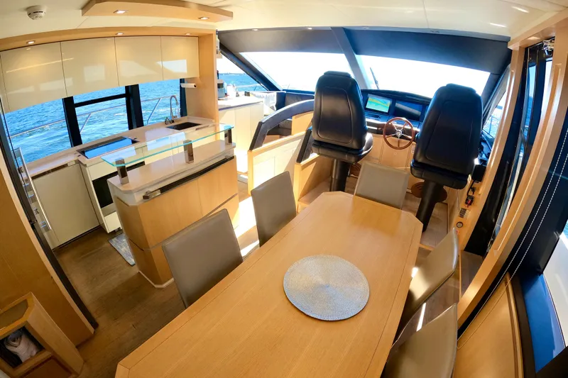  Yacht Photos Pics Luxurious interior of 2016 Absolute 72 FLY yacht with dining area and helm.