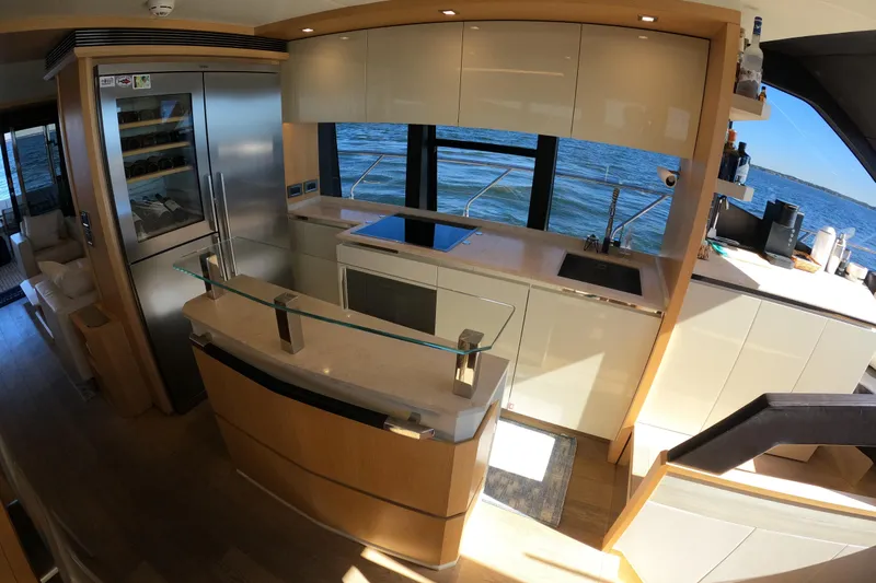  Yacht Photos Pics Luxurious kitchen interior of 2016 Absolute 72 FLY yacht with modern appliances and ocean view.
