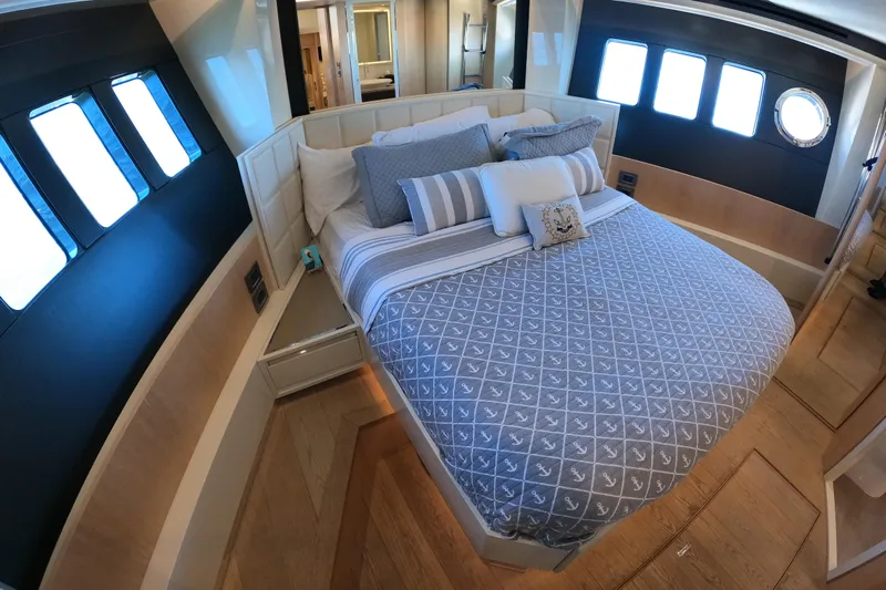  Yacht Photos Pics Luxurious bedroom interior of 2016 Absolute 72 FLY yacht with elegant bedding and ample natural light.
