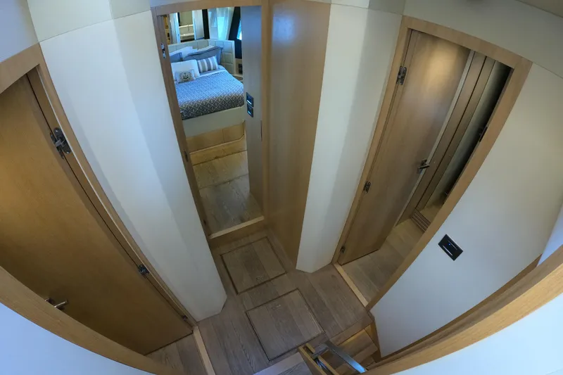  Yacht Photos Pics Interior hallway of 2016 Absolute 72 FLY yacht with wooden doors and bedroom view.