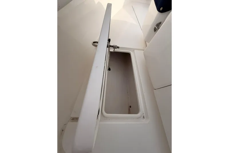  Yacht Photos Pics Open storage compartment on a Contender boat, showcasing interior space.