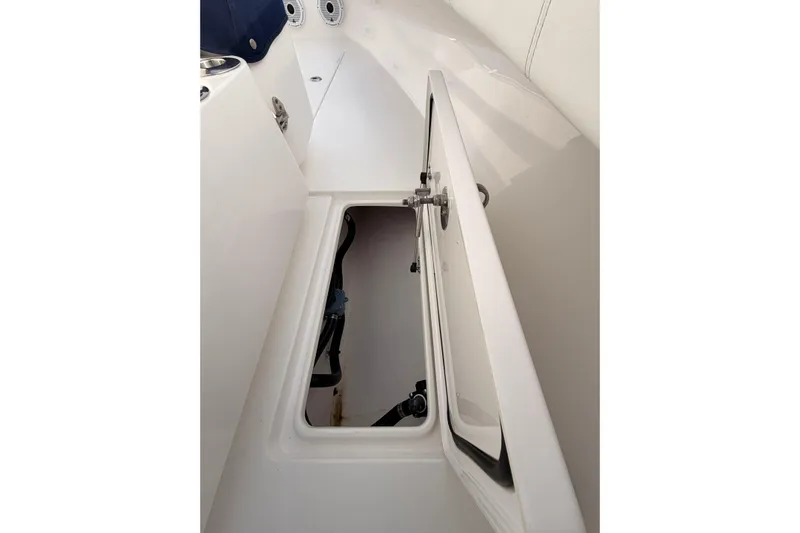  Yacht Photos Pics Open storage compartment on a Contender boat, showcasing interior space and design.