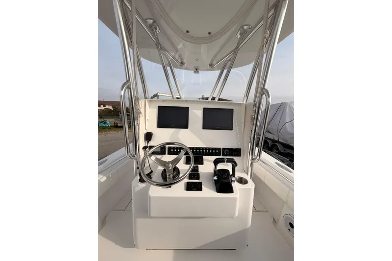  Yacht Photos Pics Contender boat helm with dual screens, steering wheel, and controls.