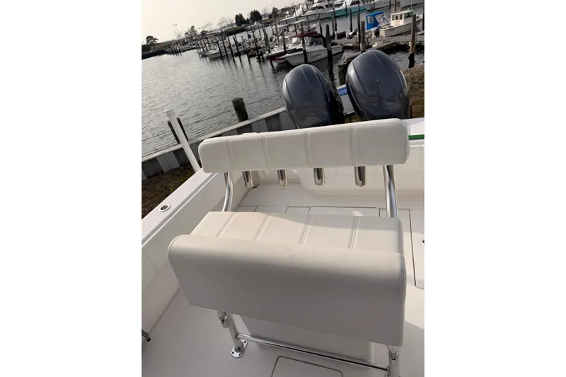  Yacht Photos Pics Contender boat with dual engines and white seating at a marina dock.
