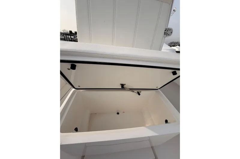  Yacht Photos Pics Open storage compartment on a Contender boat, showcasing spacious interior design.