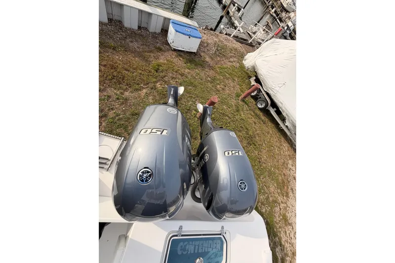  Yacht Photos Pics Twin Yamaha 150 outboard motors on a Contender boat near a dock.