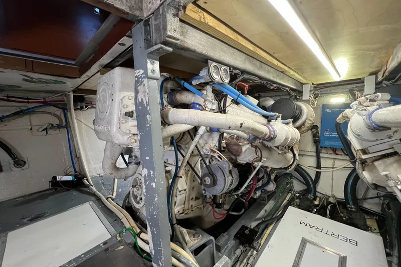  Yacht Photos Pics Engine room of a 1985 Bertram 46 Convertible boat, showcasing mechanical components and wiring.