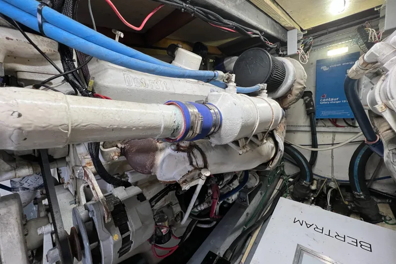  Yacht Photos Pics Engine room of a 1985 Bertram 46 Convertible yacht, showcasing mechanical components and wiring.