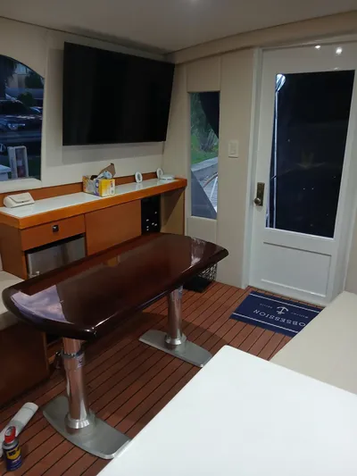  Yacht Photos Pics Interior of a 1985 Bertram 46 Convertible yacht with modern amenities and wooden flooring.