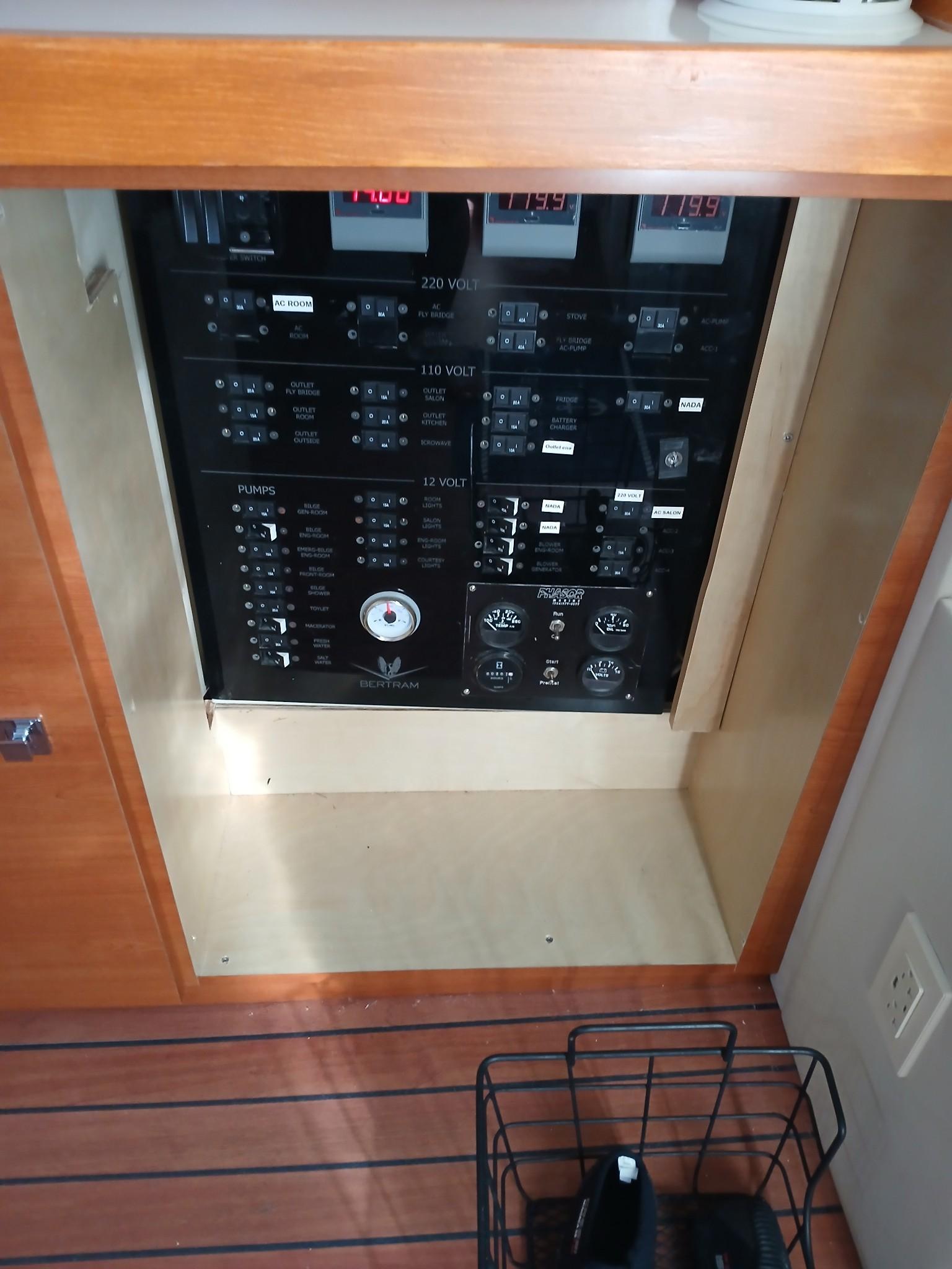 Electrical panel of a 1985 Bertram 46 Convertible yacht, featuring various switches and meters.