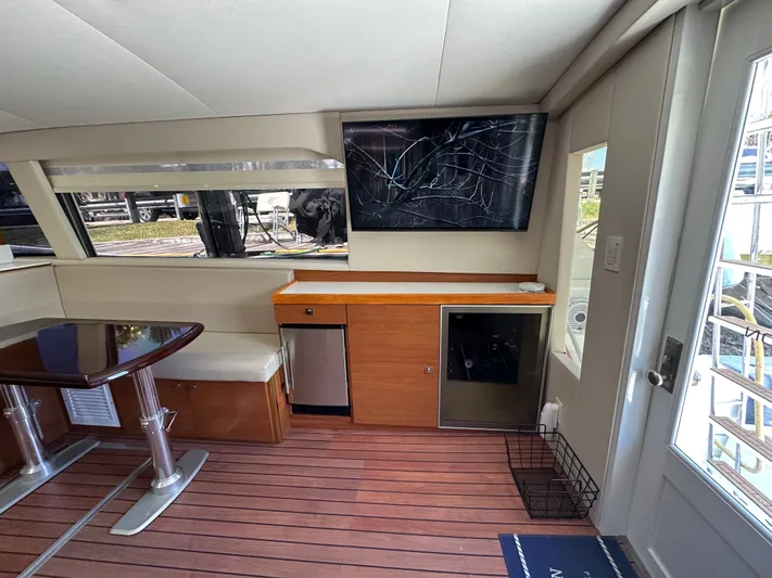  Yacht Photos Pics Interior of 1985 Bertram 46 Convertible yacht with seating, table, and TV.