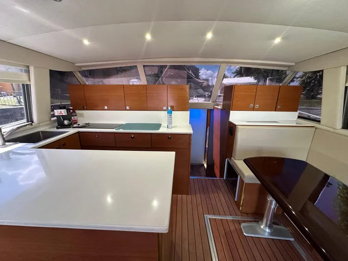  Yacht Photos Pics Interior of 1985 Bertram 46 Convertible yacht with modern kitchen and dining area.