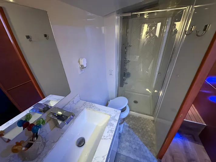  Yacht Photos Pics Luxurious bathroom in a 1985 Bertram 46 Convertible yacht, featuring a modern sink and shower.