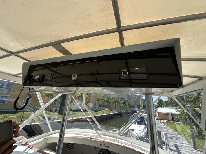  Yacht Photos Pics 1985 Bertram 46 Convertible boat helm with navigation equipment under canopy.
