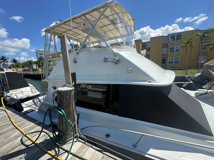  Yacht Photos Pics 1985 Bertram 46 Convertible yacht docked under clear blue sky.