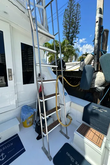  Yacht Photos Pics 1985 Bertram 46 Convertible yacht deck with ladder and nautical equipment.