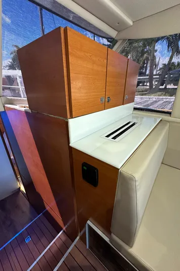  Yacht Photos Pics 1985 Bertram 46 Convertible interior with wooden cabinetry and seating.