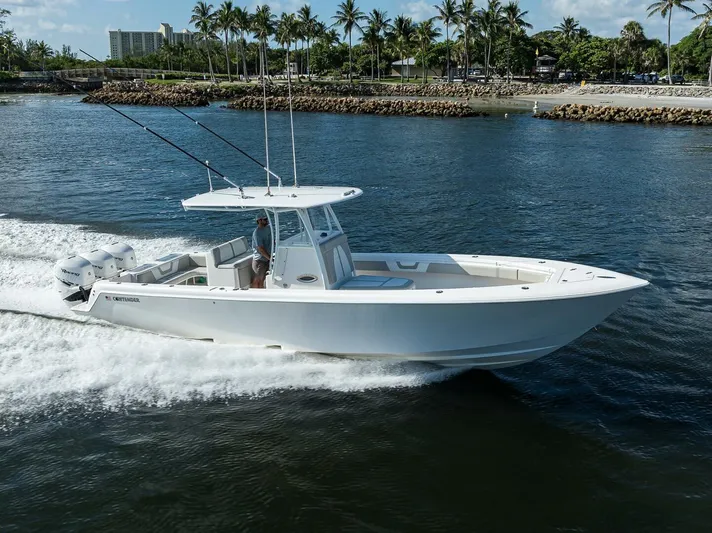 Baker Acted Yacht Photos Pics 2020 Contender 35ST boat cruising on water near a tropical shoreline.