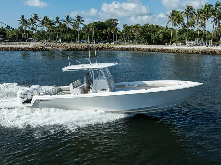 Baker Acted Yacht Photos Pics 2020 Contender 35ST boat cruising on water near a tropical shoreline.